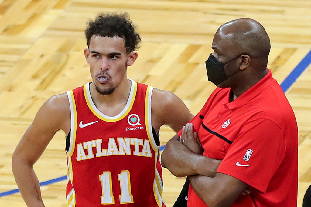 Nate McMillan and Trae Young of the Atlanta Hawks